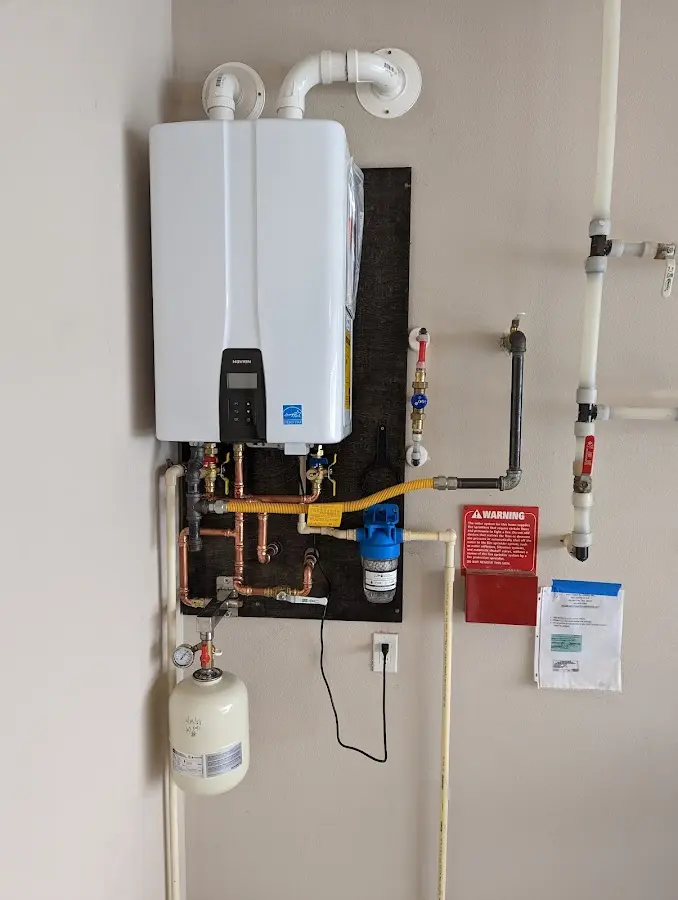 Professional plumber installing copper piping in a North College Hill home